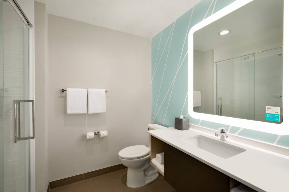 A bright bathroom with backlit mirror